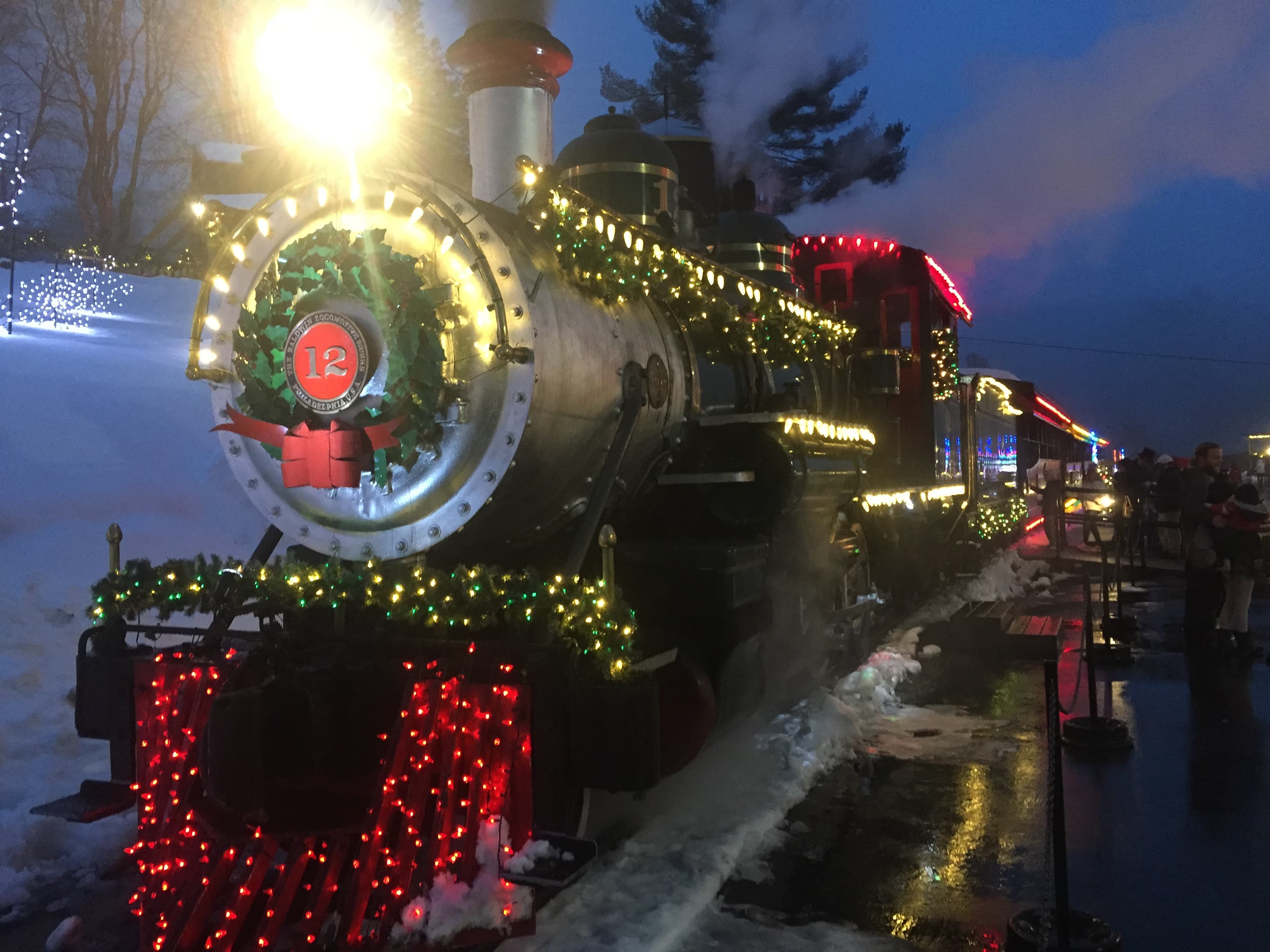 Illustrative stock photo: Tweetsie Railroad locomotive No. 12 with Christmas lights and a wreath at the station