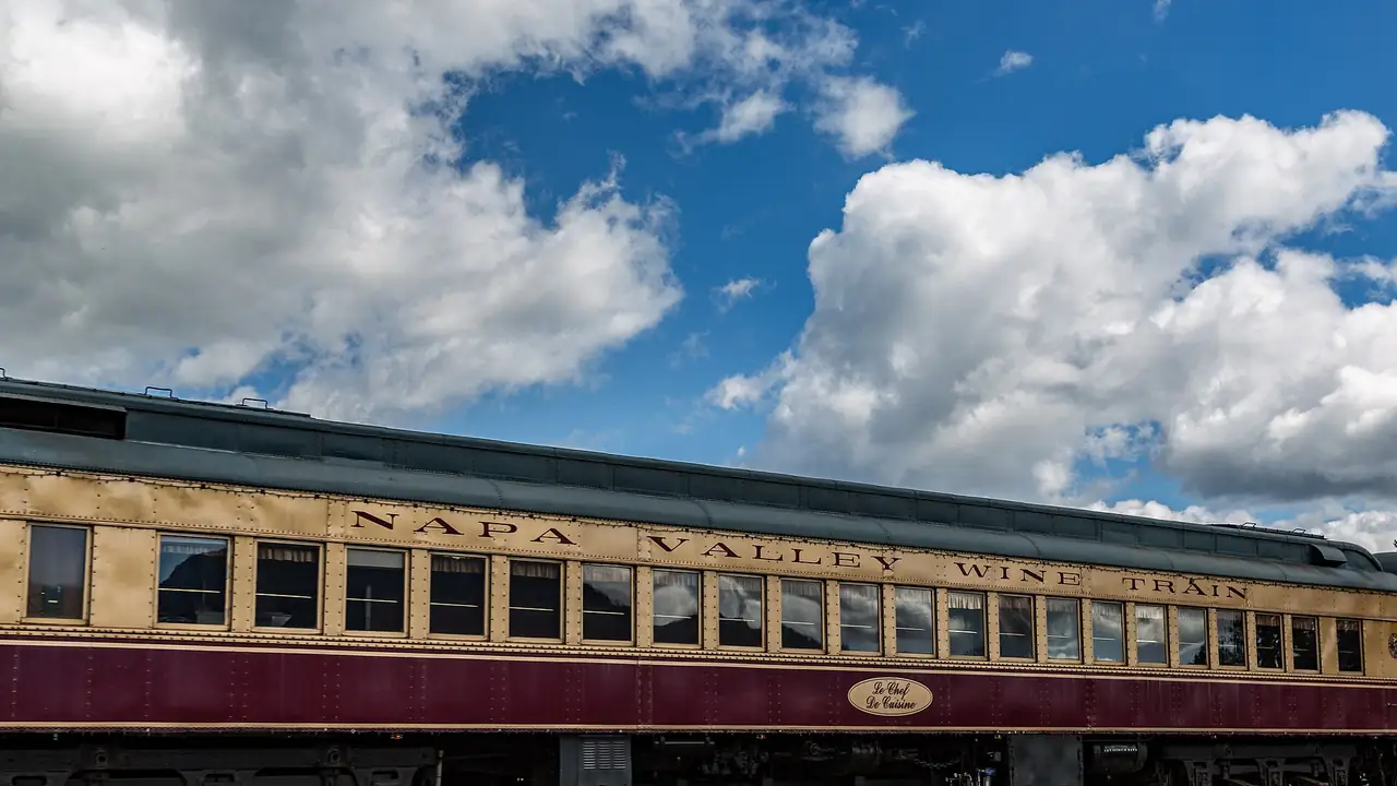 Napa Valley Wine Train vintage passenger car beneath a blue California sky