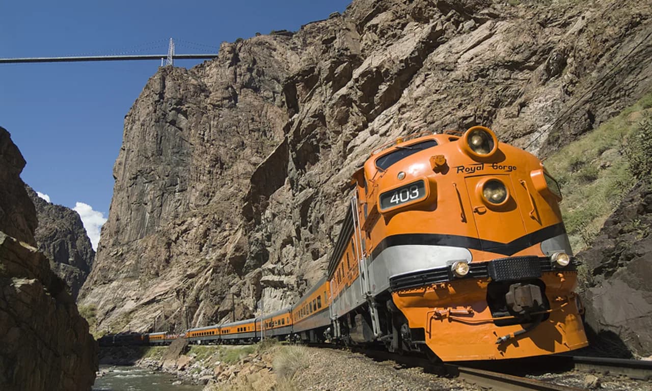 Royal Gorge Route Railroad locomotive 403 leading passenger cars through the canyon