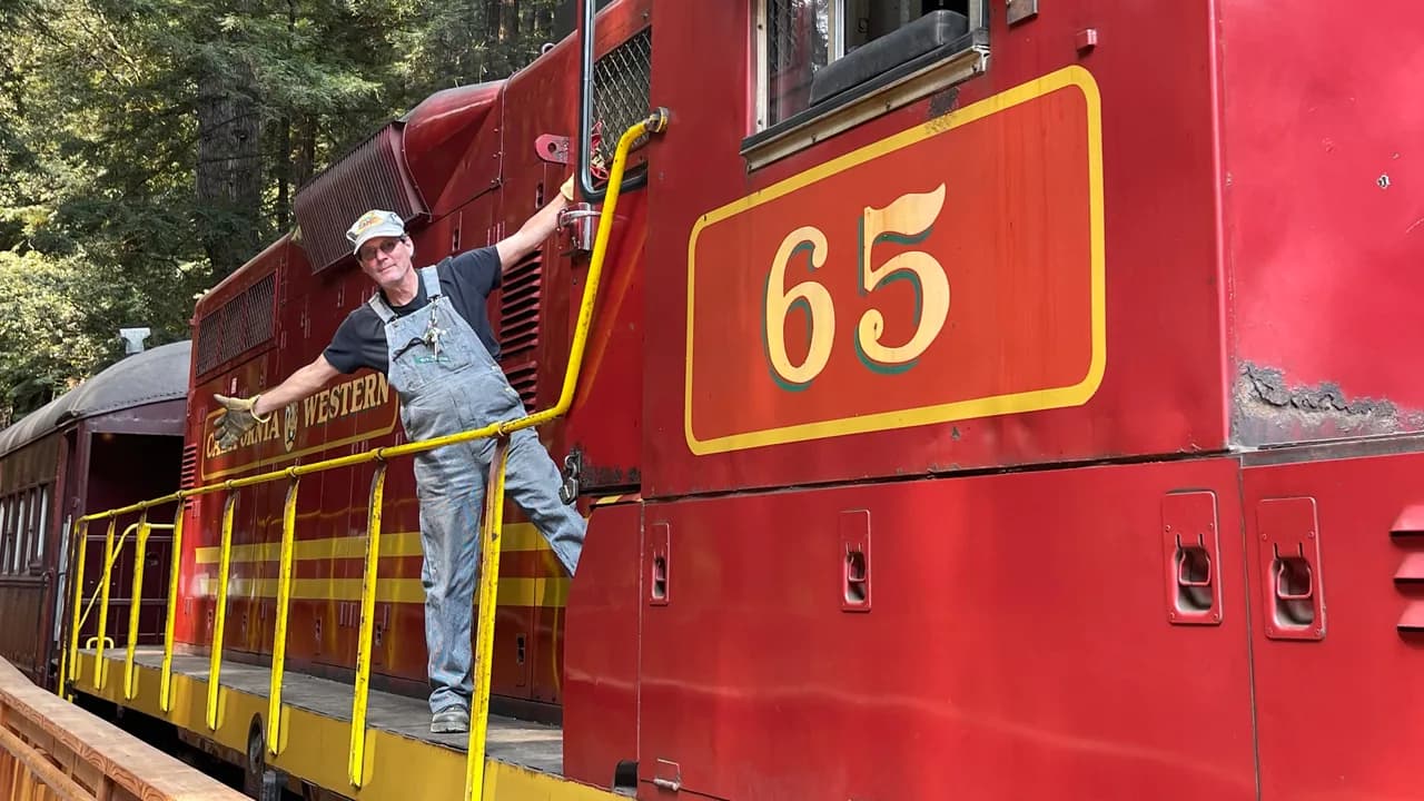 Engineer beside California Western Railroad locomotive 65 at the Skunk Train