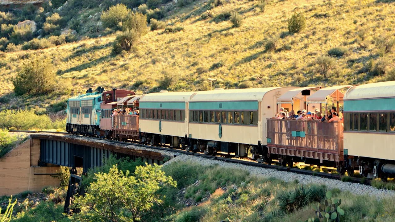 Verde Canyon Railroad passenger train crossing a bridge through Arizona canyon country