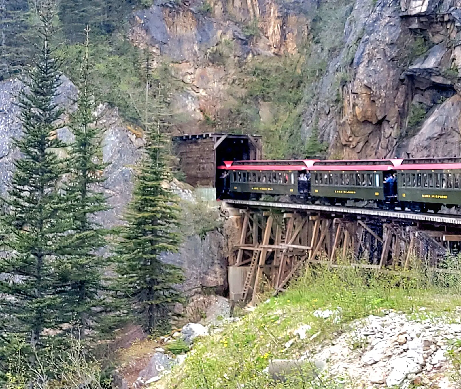 White Pass and Yukon Route passenger train entering a mountainside tunnel