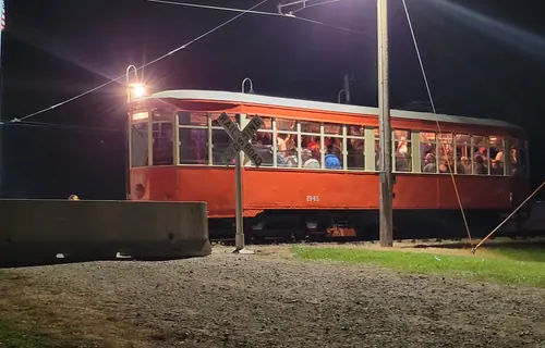 Illuminated Midwest Electric Railway streetcar operating at night